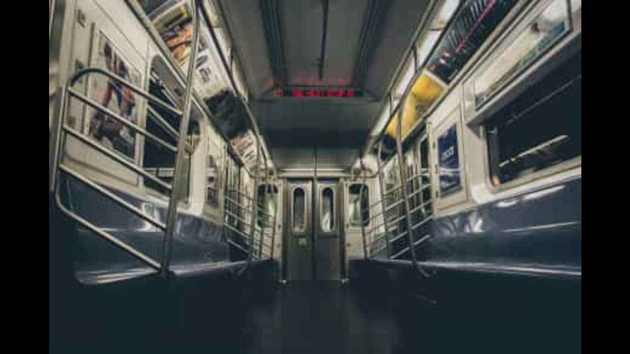 Man wildly spinning around on the subway