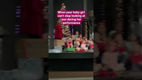 Presence Matters. Little Girl Can’t Stop Smiling at Mom During School Christmas Show.