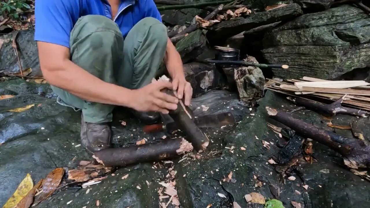 Building a bamboo shelter on a rock face:5