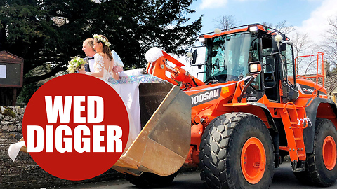 A JCB driver and his new bride ride in bucket of big digger on their wedding day