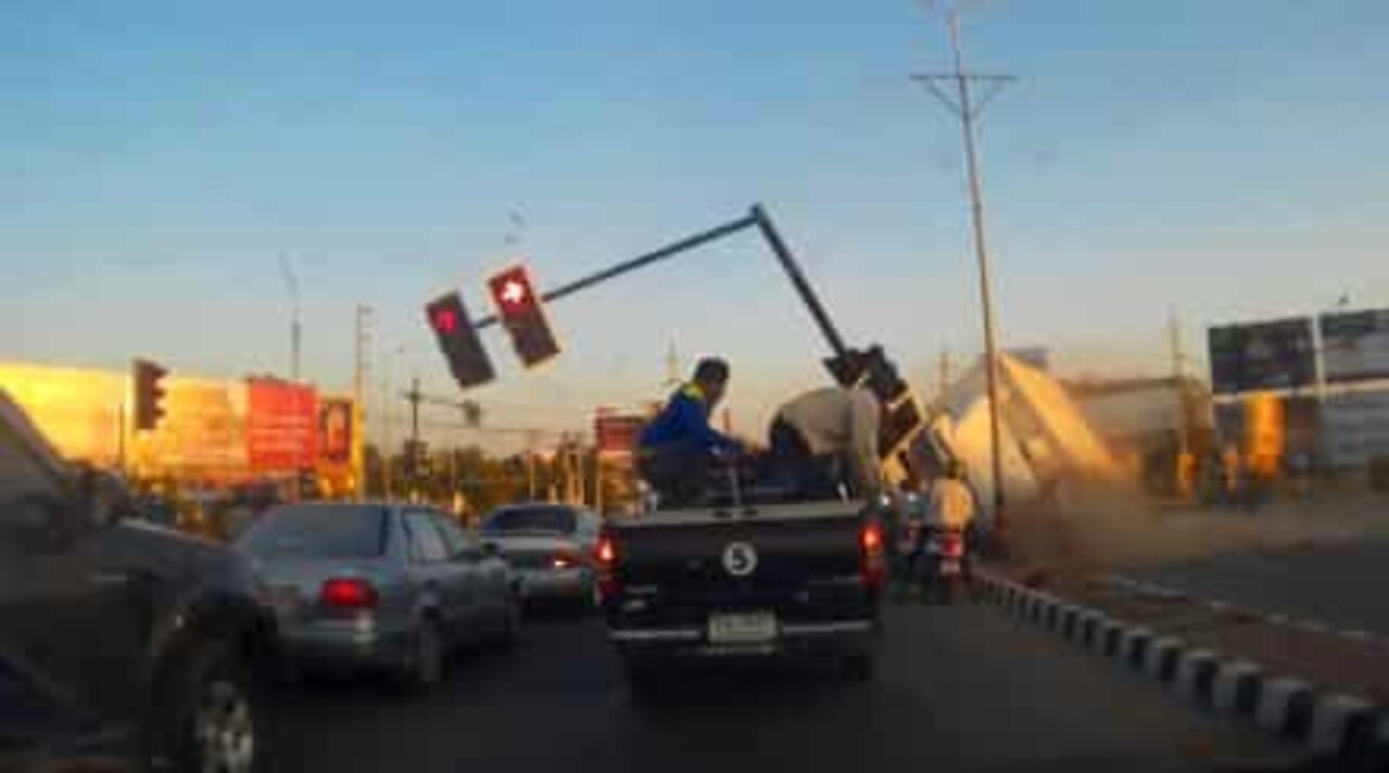 Caminhão capota e destrói semáforo