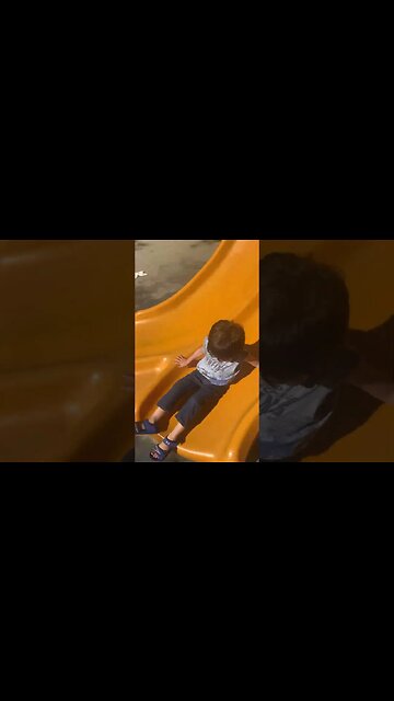Baby boy loves the slide -beautiful day at park