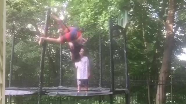 "Two Boys Jump On A Trampoline And One Is Launched Onto The Net"