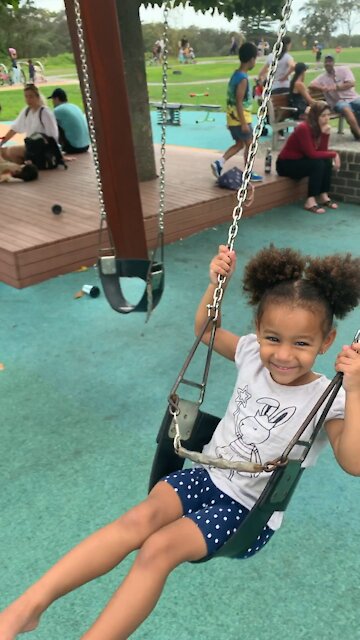 Smiling on the swing
