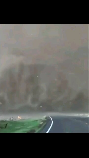 Tornado: Massive Tornado crossing the road. A little to close for my comfort.