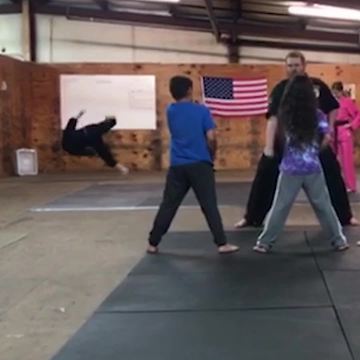 Guy Falls in The Background of Karate Practice Video