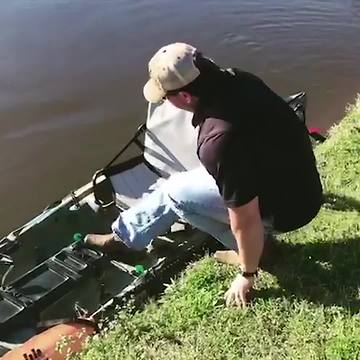 Man Tries To Climb Into Canoe But It Tips Over And He Falls Out