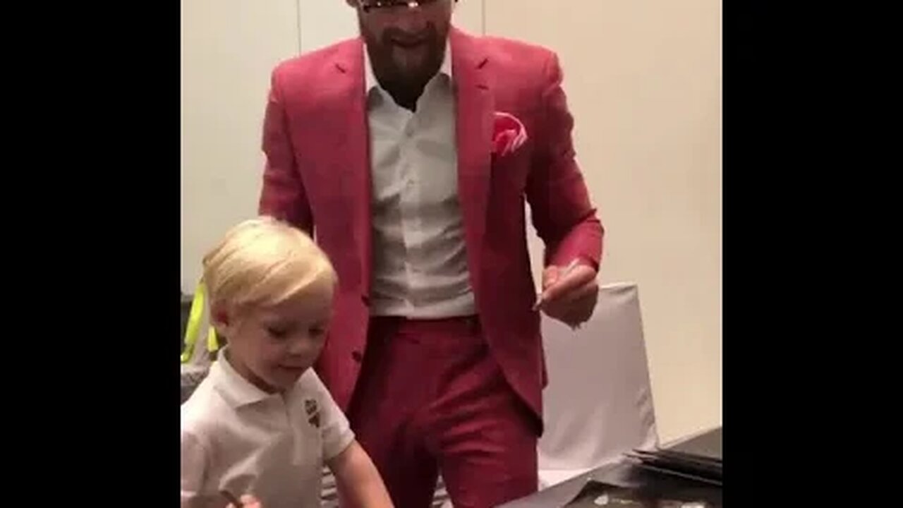 Conor Mcgregor and Jr signing posters on fight island Abu Dhabi for UFC 257