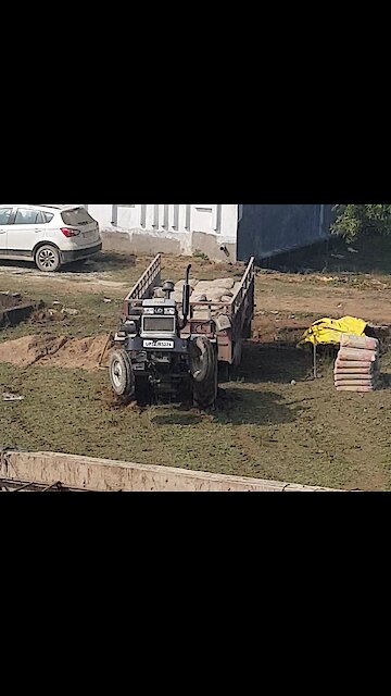 Tractor doing stunts after getting stuck in the mud.