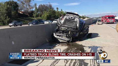 Flatbed truck blows tire, crashes on I-15