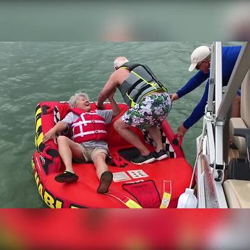 An Old Couple Tries To Get On Inflatable Tube