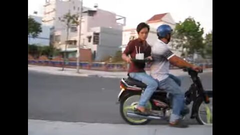 Vietnam, Binh Duong, Thu Dau Mot - motorbike waiter 2013