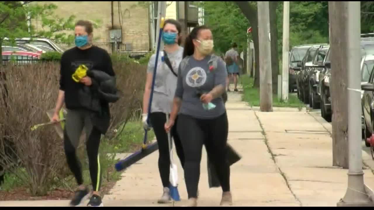 Volunteers show up to clean up following looting, destruction