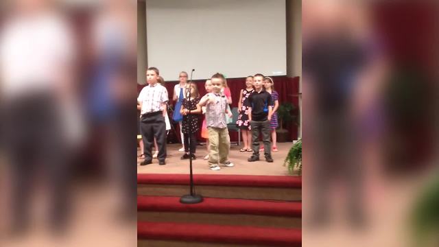 A Boy Dances Wildly While Singing In A Choir