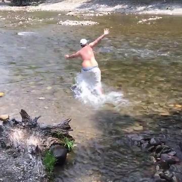 A Guy In A River Gets Knocked Over By Current