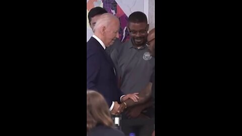 Joe Biden rubs this man’s arm?