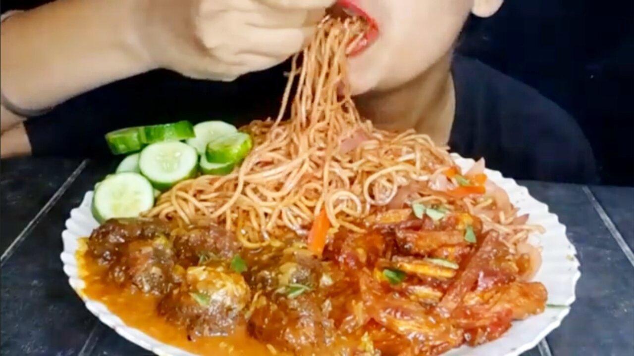 Eating spicy noodles with manchurian chilli potato