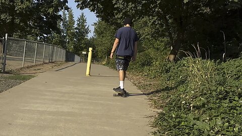 Yung Paul Riding Longboard At Dog Park