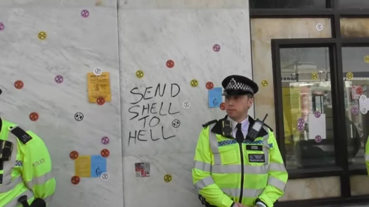 Send shell to hell police stop extinction rebellion from graffitiing shell building