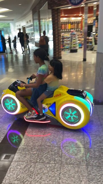 Daughter and son playing at the mall