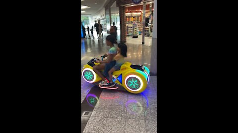 Daughter and son playing at the mall
