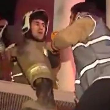 The firefighter rather doing his job than speaking to reporter