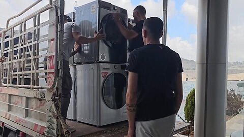 Store owners collect goods for removal in a Lebanese border town amid fears of supply shortage