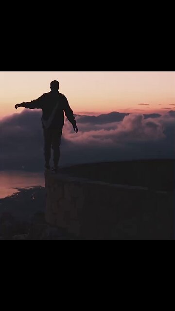Man sneaking on the top of a wall with beautiful sky code
