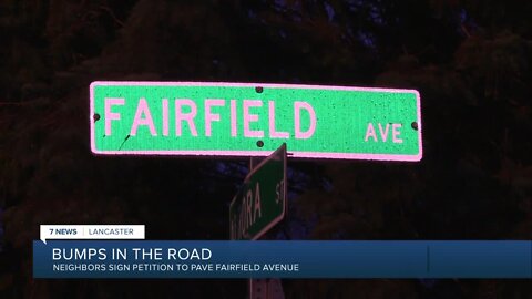 Neighbors in one Lancaster community is signing a petition to have their road paved after years of waiting