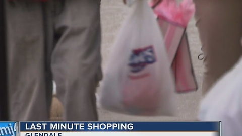 Last-minute Christmas shoppers fill the streets