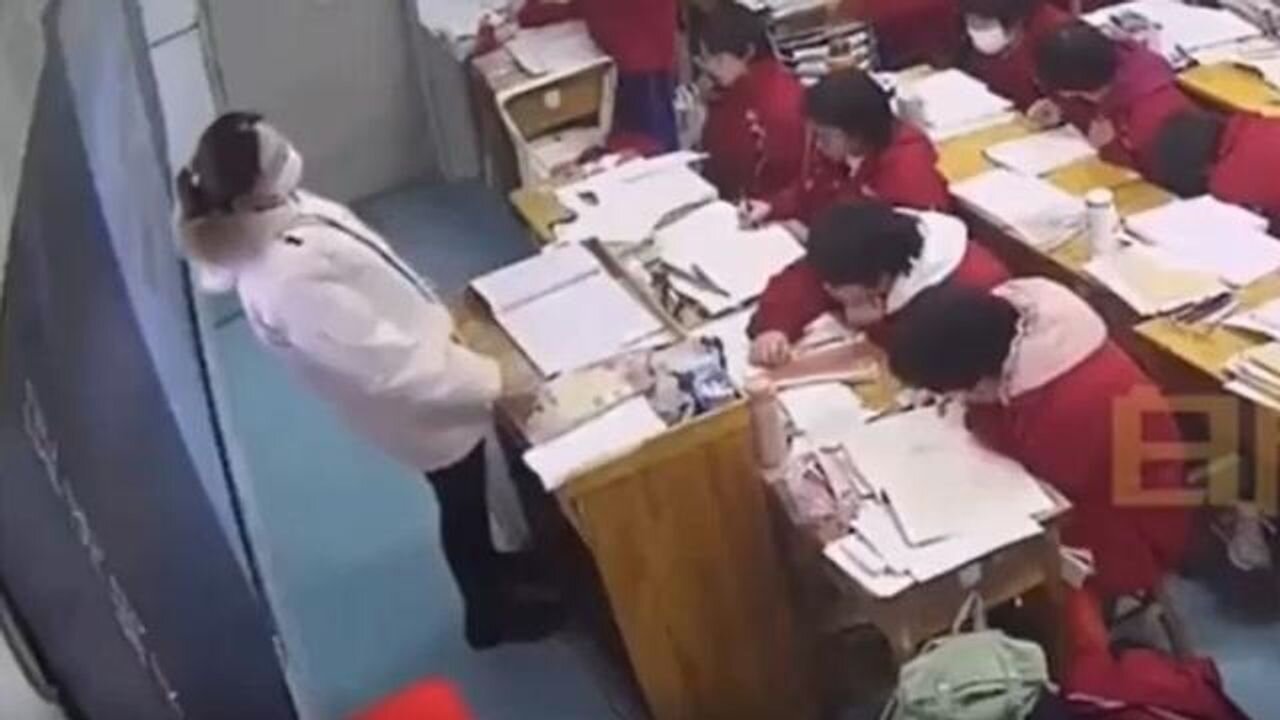 A young Asian teacher, suddenly collapses during class