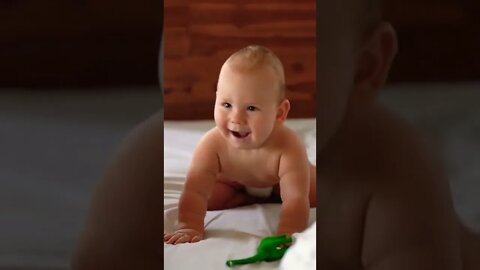 Happy Funny Baby Playing On Bed