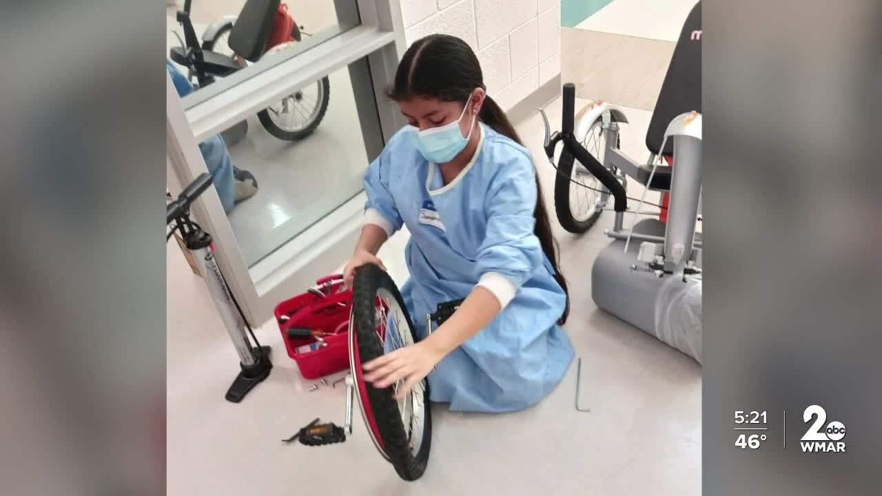 12-year-old Samantha Jeronimo helps students fix bikes in Bike Doctors program