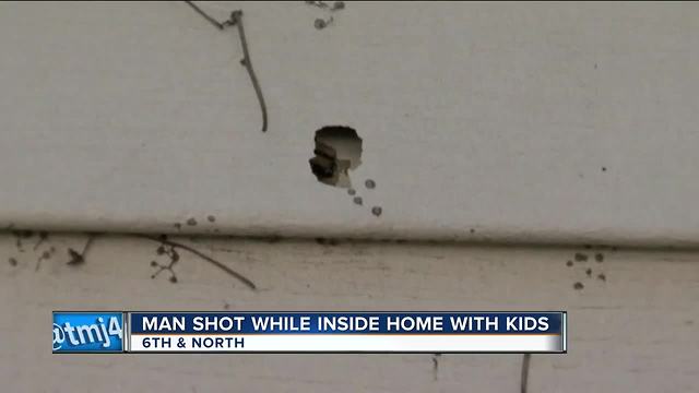 Stray bullet hits man feeding baby in home during shootout