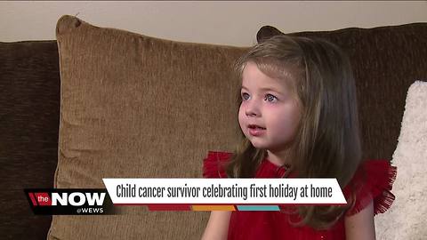 Child cancer survivor celebrating first Christmas at home