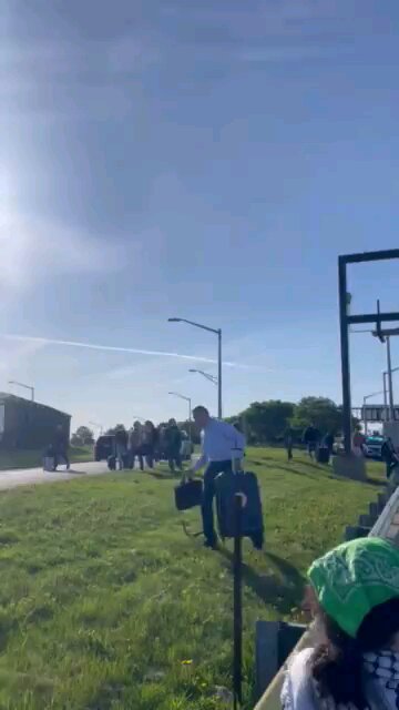 Leftist protestors blocking road to O'Hare Airport, people walking on for to catch flights.