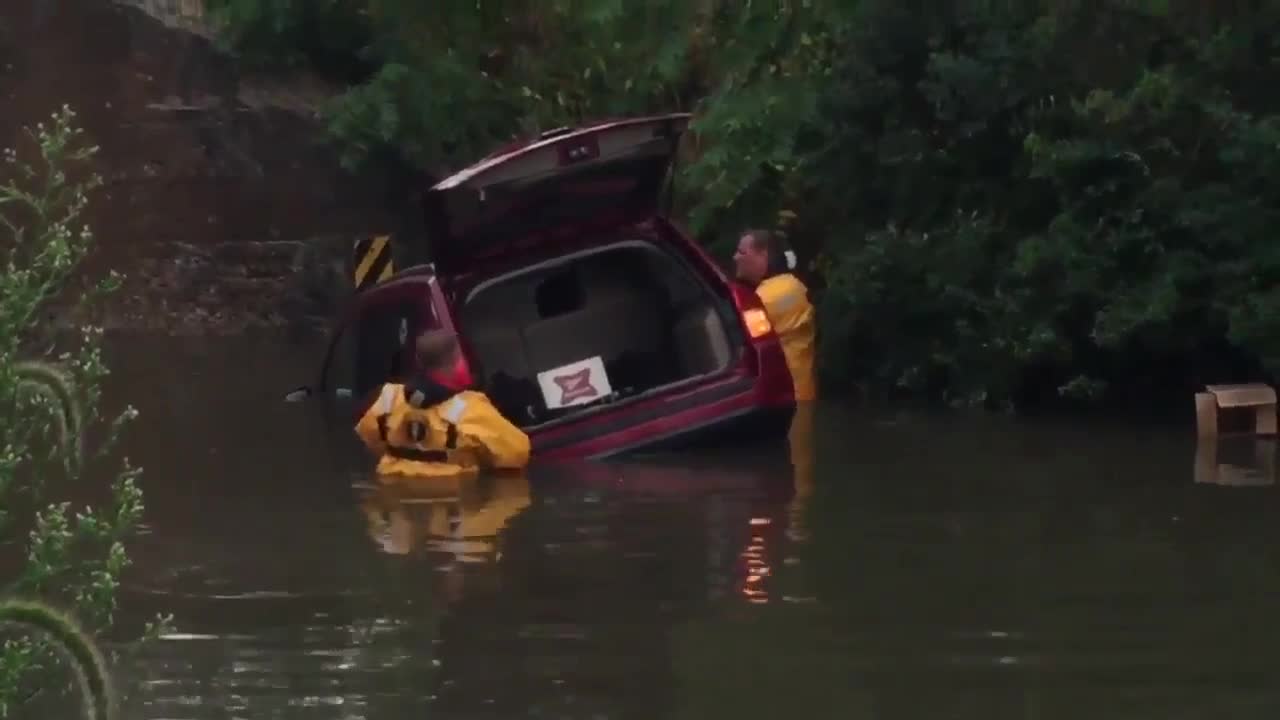 Vehicle stranded by rising floodwaters in Watertown