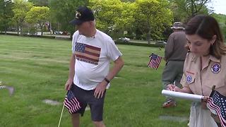 Veterans place flags on graves of fallen soldiers