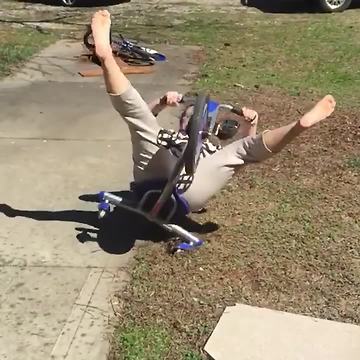 A Woman Slides On a Tricycle and Falls backwards