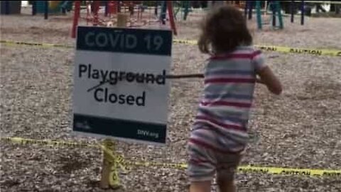 Disappointed child takes frustration out on playground 'closed' sign