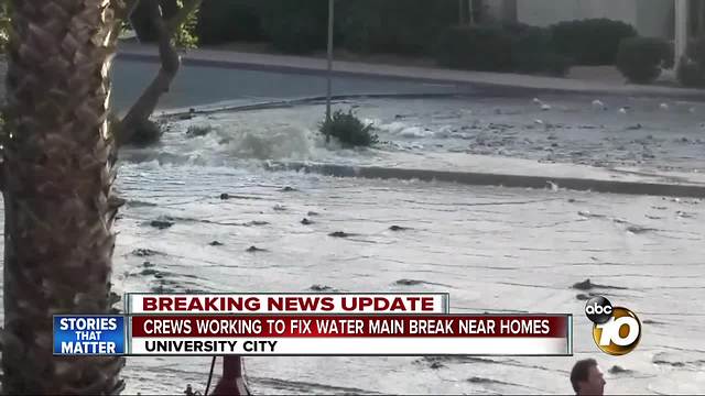 Crews working to fix water main break near homes