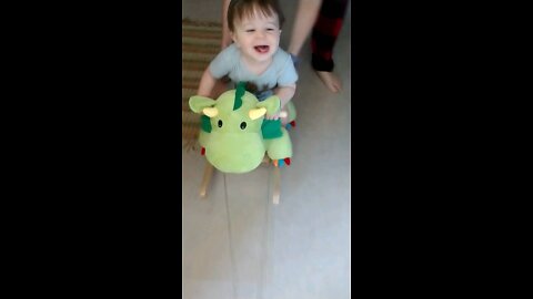 Riding his rocking dinosaur!