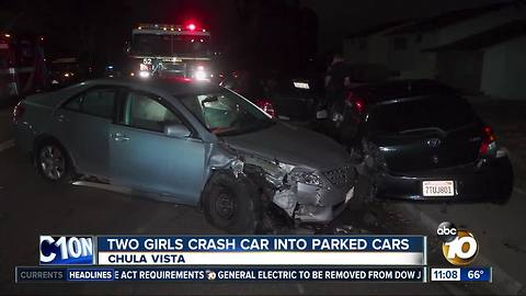 Two girls crash car into parked cars