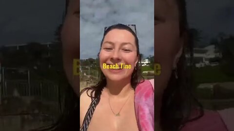 Woman shows off girls on beach.