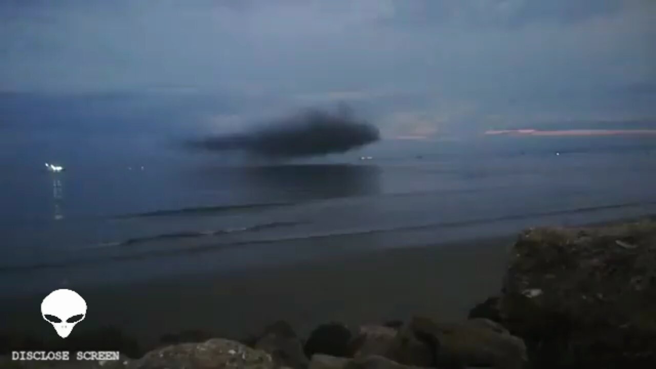 spicious looking cloud hovering right above the oceans surface during sun set in Ecuador.