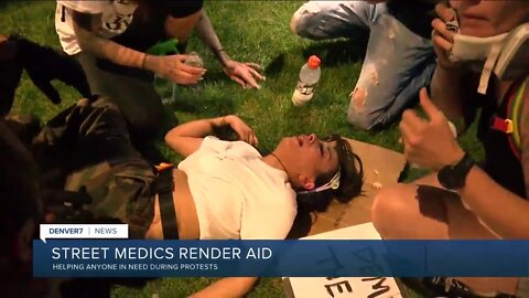 Street medics aid demonstrators hit by tear gas during George Floyd protests in Denver