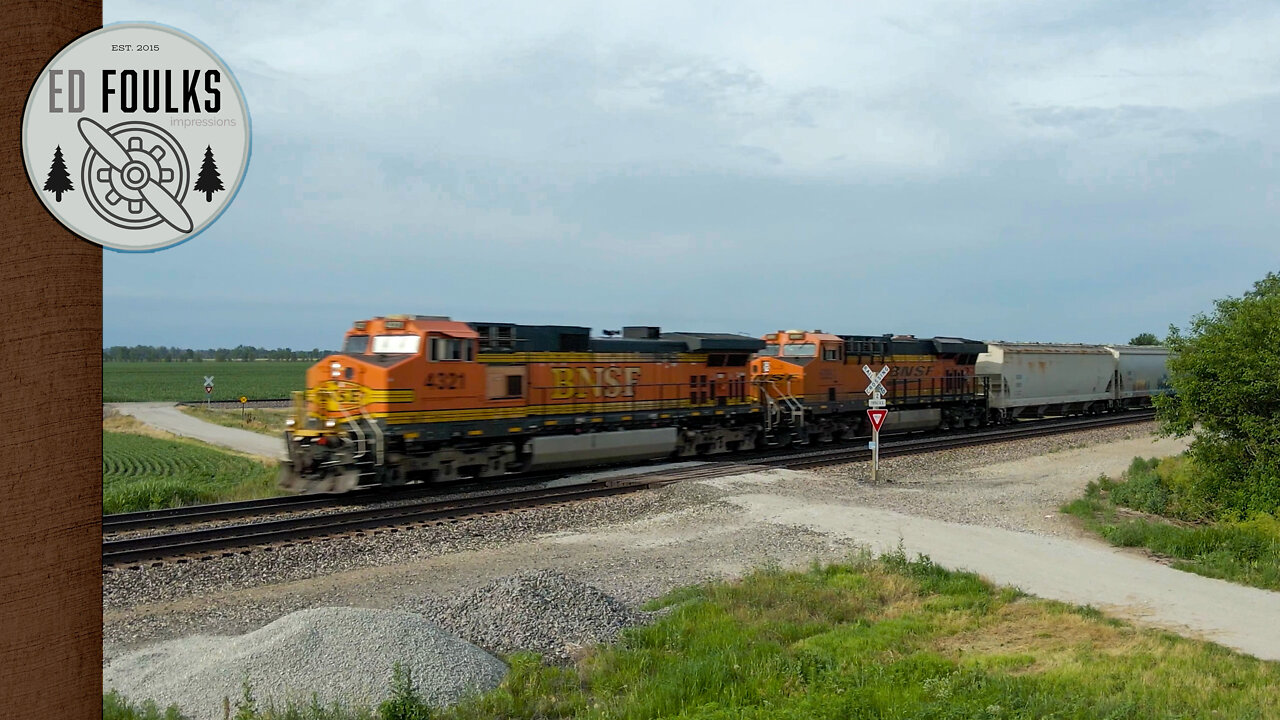 Fast moving BNSF manifest train reveals itself from behind the trees