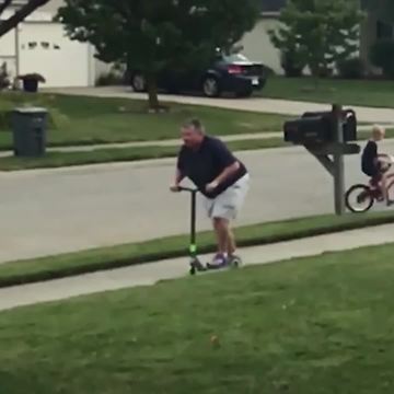 Woman Riding Scooter Falls Onto Sidewalk