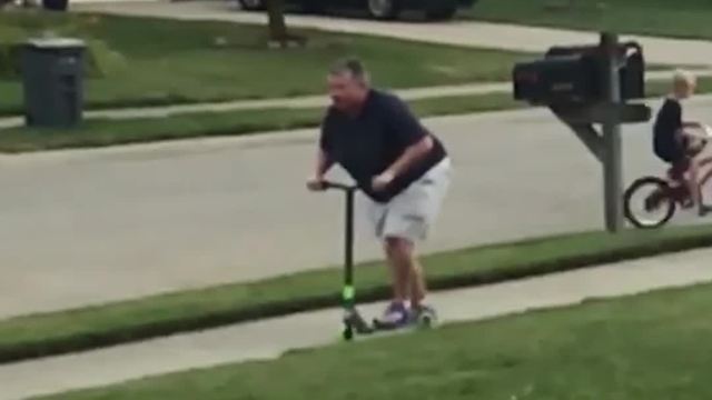 Woman Riding Scooter Falls Onto Sidewalk