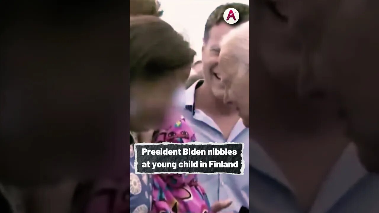 President Biden nibbles at young child in Finland